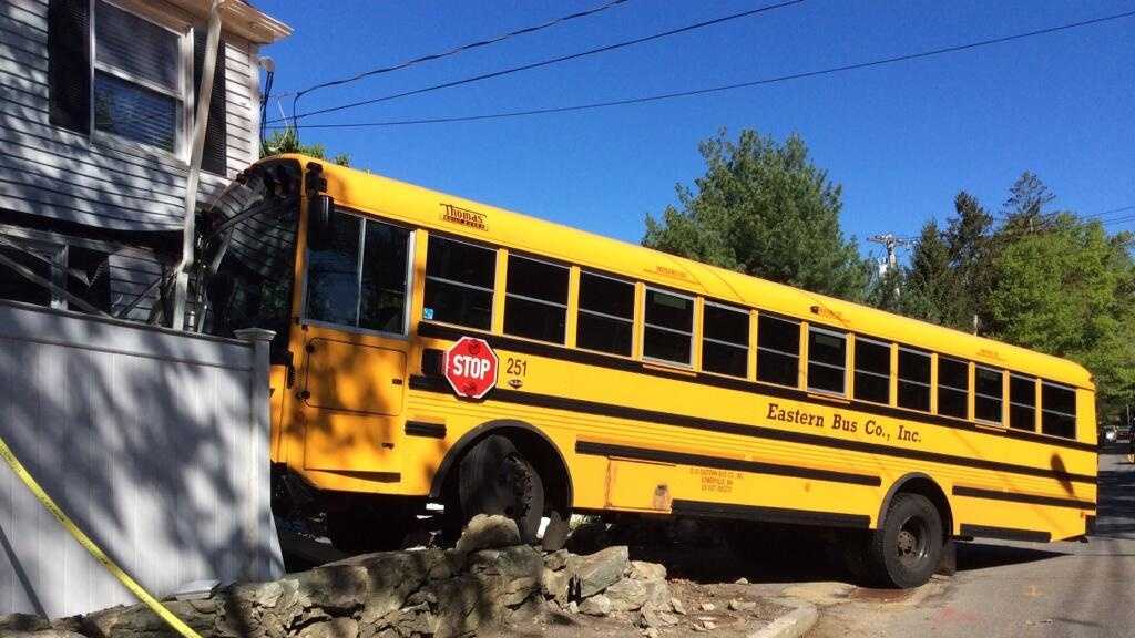 School bus crashes into home