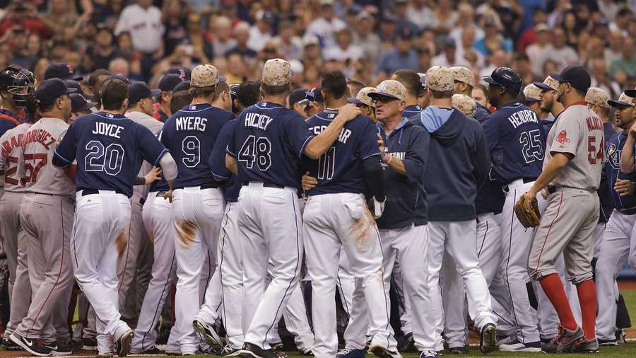 Tampa Bay Rays manager Joe Maddon ,center right, and pitching coach Jim Hickey (48) restrain Yunel Escobar (11) during a benches-clearing brawl during the seventh inning of a baseball game against the Boston Red Sox Sunday, May 25, 2014 in St. Petersburg, Fla. The Rays beat the Red Sox 8-5. (AP Photo/Steve Nesius)