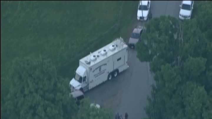Authorities say police are searching for a man in South Hampton, New Hampshire, reported to have a long gun and who may be wearing body armor.