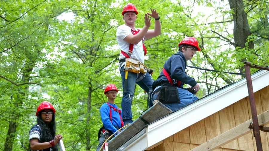 Students from the Greater Lowell Technical High School work on a cabin-building project at Camp Massapoag in Dunstable, Mass., Thursday, May 21, 2014.