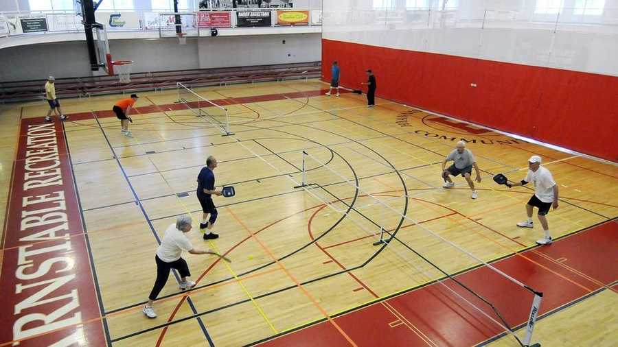 In this May 28, 2014, photo, groups of four play games of pickleball at at the Youth and Community Center in Hyannis, Mass. Pickleball may be one of the fastest growing sports in the United States among seniors, and the Cape is no exception.