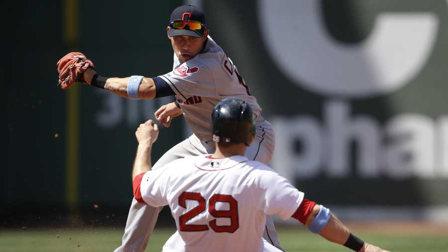 Boston Red Sox's Daniel Nava (29) slides out on a steal attempt as Cleveland Indians shortstop Asdrubal Cabrera, top, tags him in the fourth inning of a baseball game, Sunday, June 15, 2014, in Boston. (AP Photo/Steven Senne)
