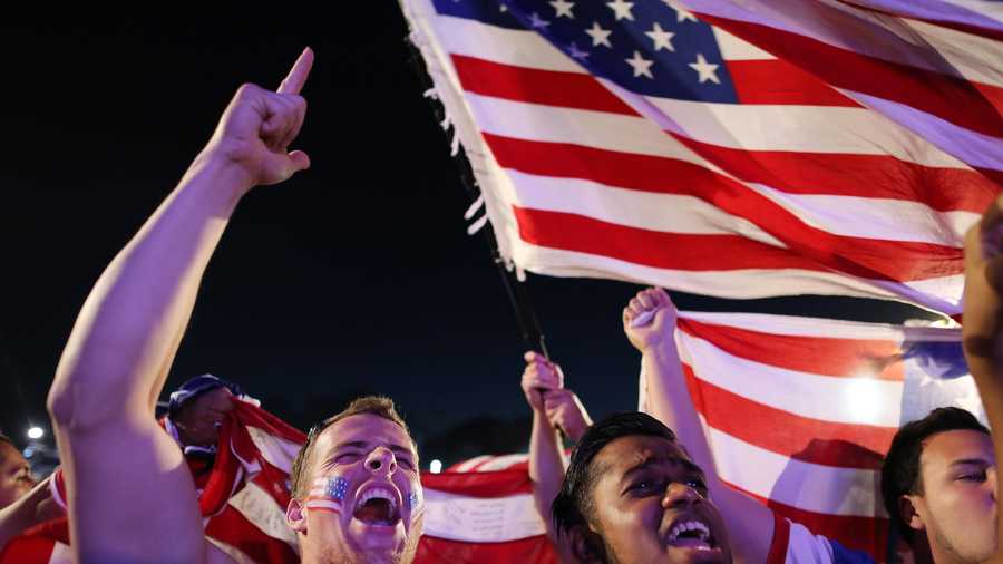 Fans of the U.S. national soccer team cheer before a live telecast of the group G World Cup match between United States and Portugal, inside the FIFA Fan Fest area on Copacabana beach, in Rio de Janeiro, Brazil, Sunday, June 22, 2014.