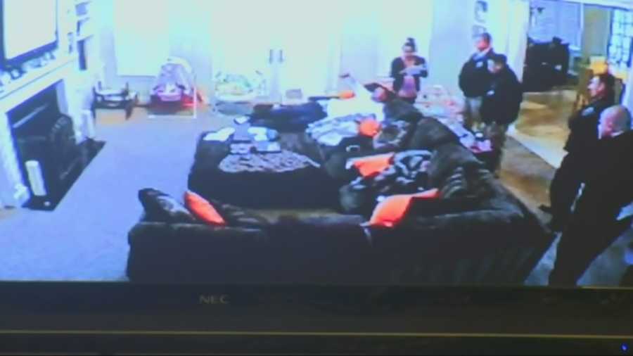 Prosecutors showed surveillance video from Aaron Hernandez's home showing Sgt. Paul Baker arrive to execute search warrants. Hernandez can be seen stretched out on his couch while authorities are in the house.