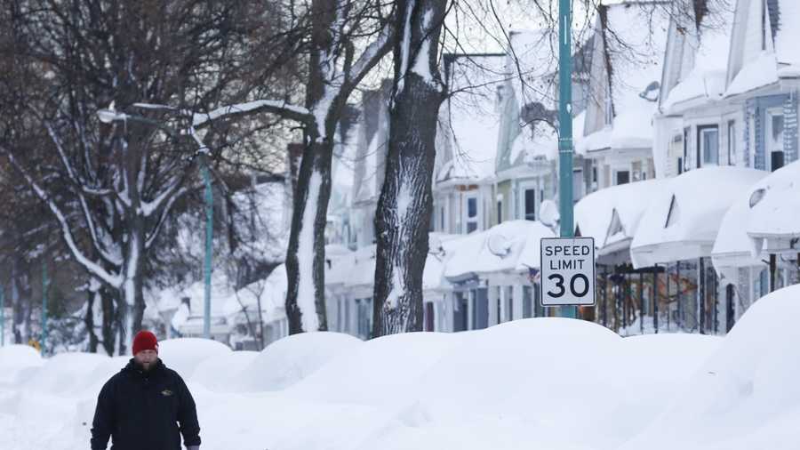 Chris Weiglein walks along his snow-bound south Buffalo neighborhood on Thursday, Nov. 20, 2014, in Buffalo, N.Y.