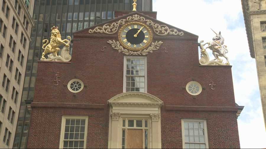 Two iconic statues returned to Boston's historic Old State House Sunday following a complete restoration.