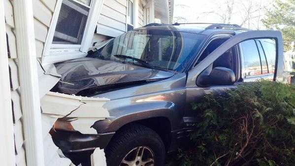 Driver arrested after car crashes into house