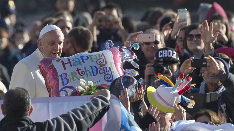 Pope Francis stands by a balloon reading Happy Birthday as he arrives for his weekly general audience in St. Peter's Square at the Vatican, Wednesday, Dec. 17, 2014. Pope Francis celebrates his 78th birthday Wednesday.