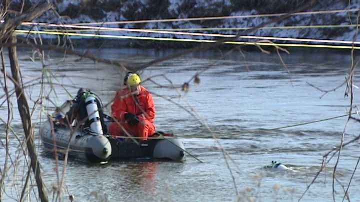 Crews attempt to recover a submerged car and passenger