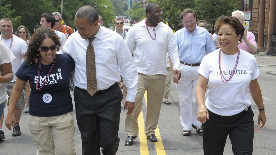 Gov. Deval Patrick, second from left, puts his arm around his daughter Katherine Patrick, left, as he walks with his family in the gay pride parade, Saturday, June 14, 2008 in Boston. Patrick's wife Diane Patrick is walking at right.