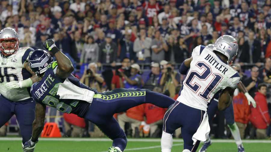 New England Patriots strong safety Malcolm Butler (21) intercepts a pass in front of Seattle Seahawks wide receiver Ricardo Lockette (83) in Super Bowl XLIX  Sunday, Feb. 1, 2015, in Glendale, Ariz., clinching the Patriots fourth Super Bowl win.