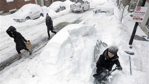 Taylor LaBrecque digs her car out of a snow pile on Beacon Hill.