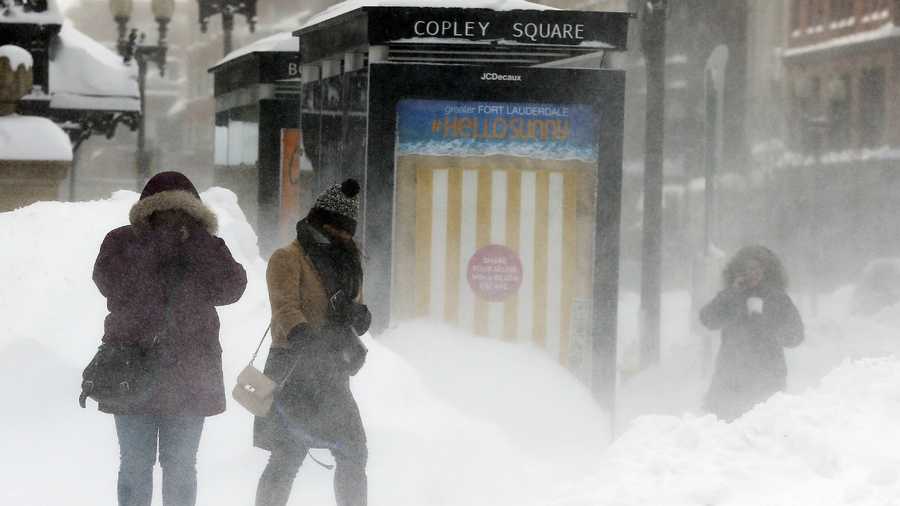 Pedestrians brace against blowing snow in Copley Square in Boston, Sunday, Feb. 15, 2015. A storm brought a new round of wind-whipped snow to New England on Sunday, threatening white-out conditions in coastal areas and forcing people to contend with a fourth winter onslaught in less than a month.