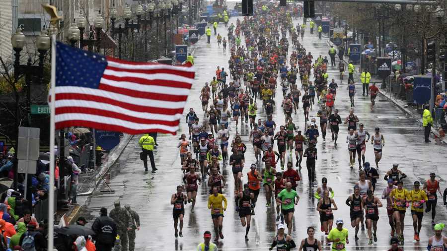 Runners approach the finish line in the rain during the Boston Marathon, Monday, April 20, 2015, in Boston.