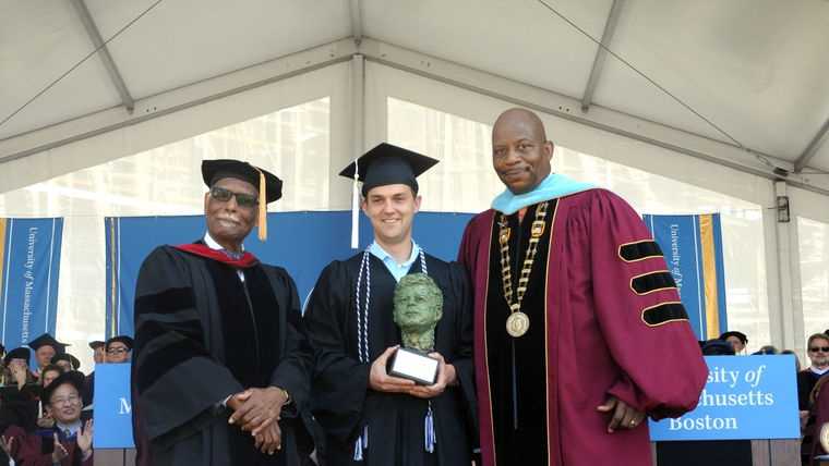 University of Massachusetts Provost Winston Langley, left, and Chancellor J. Keith Motley with Shaun O’Grady, holding the John F. Kennedy Award for Academic Excellence.