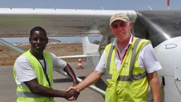 African Parks' pilot Bill Fitzpatrick (right) with an aviation official before departing from Dakar in Senegal on June 19, 2014 en route to the Republic of Congo. Fitzpatrick went missing en route between Nigeria and Cameroon.