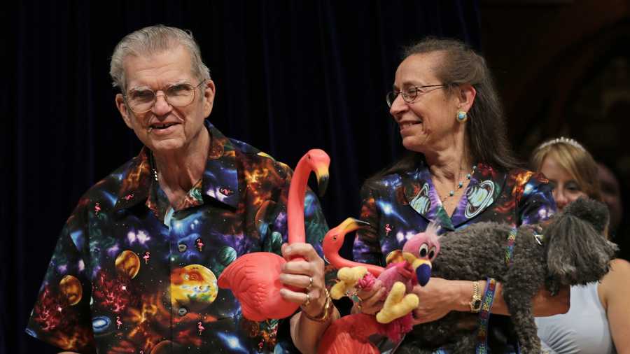 Artist Don Featherstone, 1996 Ig Nobel Prize winner and creator of the plastic pink flamingo lawn ornament, poses with his Nancy while being honored as a past recipient during a performance at the Ig Nobel Prize ceremony at Harvard University, in Cambridge, Mass., Thursday, Sept. 20, 2012.