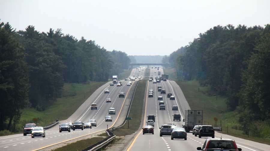a photo of traffic moving along the maine turnpike during a summer afternoon