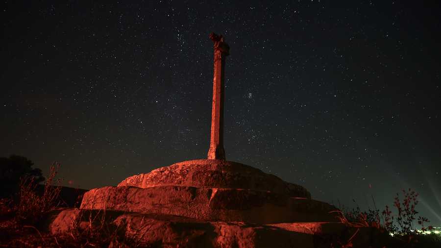 Stars seen as streaks from a long camera exposure are seen behind a Stations of The Cross, in Ujue, northern Spain, Wednesday, Aug.12, 2015. The meteor shower is expected to peak Wednesday night into Thursday morning.