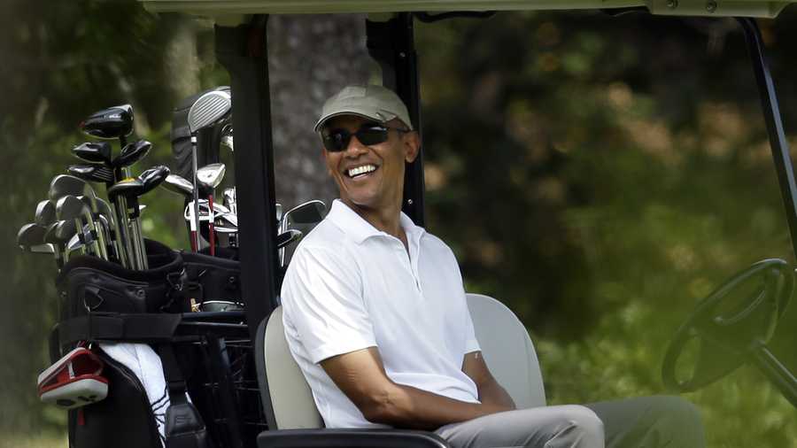 President Barack Obama smiles as he sits in a cart while golfing Saturday, Aug. 15, 2015, at Farm Neck Golf Club, in Oak Bluffs, Mass., on the island of Martha's Vineyard.