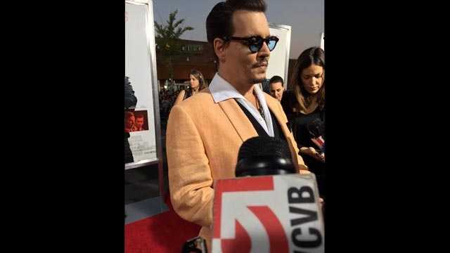 Actor Johnny Depp speaks with reporters, including NewsCenter 5's Ed Harding, before the premiere of "Black Mass" in Brookline on Sept. 15, 2015.