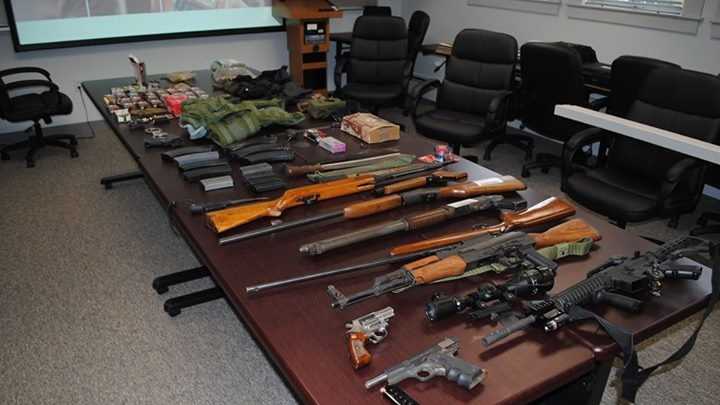 Man arrested after weapons cache found in home