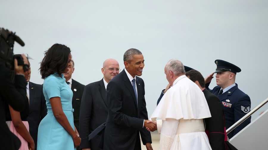 President Barack Obama, first lady Michelle Obama, and others, greet Pope Francis upon his arrival at Andrews Air Force Base, Md., Tuesday, Sept. 22, 2015. (AP Photo/Andrew Harnik)