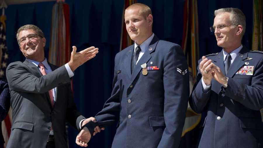 Defense Secretary Ash Carter, left, gestures towards Airman 1st Class Spencer Stone, center, before awarding Stone with the Airman's Medal and Purple Heart medal, during a ceremony with Joint Chiefs Vice Chairman Gen. Paul Selva, right, at the Pentagon, Thursday, Sept. 17, 2015. Stone along with Oregon National Guardsman Alek Skarlatos and Anthony Sadler where honored for heroically subduing a gunman on a Paris-bound passenger train last month. 