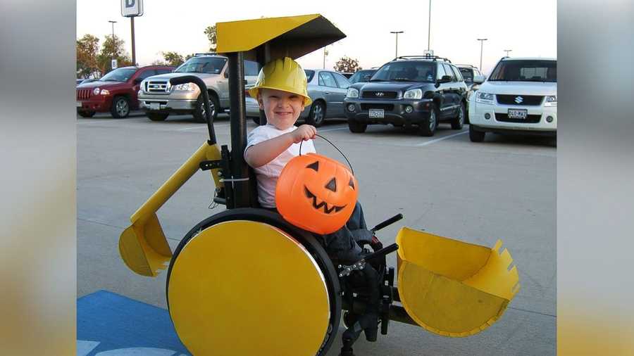 Caleb McLelland is pictured here at age 3 as "Bob the Builder" in a "Backhoe/Scoop truck" wheelchair costume designed by his mother Cassie McLelland for Halloween 2008.