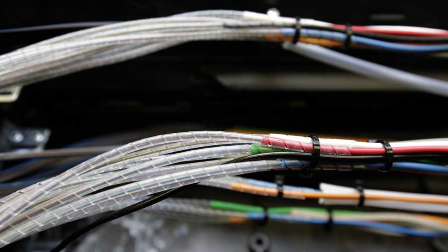 Glass fibers, housed inside narrow cables inside a box, are seen as they're being connected to the Verizon FiOS fiber network in Rockville, Md., Friday, March 13, 2009.