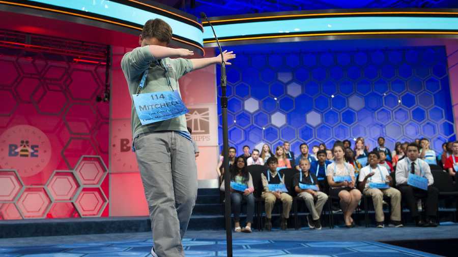 Mitchell Robson, 14, of Danvers, Mass., steps backwards while celebrating correctly spelling his word during the preliminary round three of the Scripps National Spelling Bee in National Harbor, Md., Wednesday, May 25, 2016.