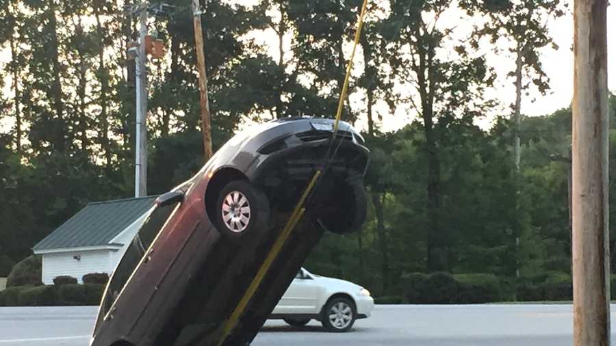 Driver following GPS directions drives car up utility pole wire