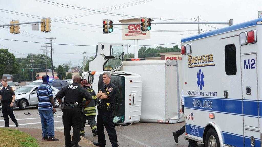 Police Driver Ran Red Light Collided With Truck That Rolled Over