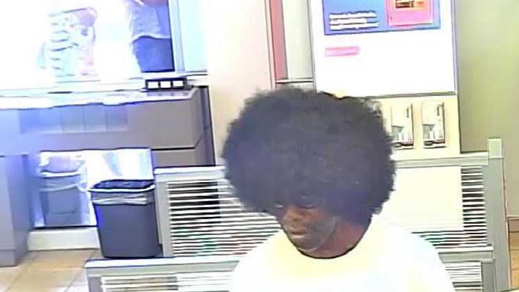 Man wearing very large Afro-style wig caught on camera robbing bank Man wearing very large Afro-style wig caught on camera robbing bank