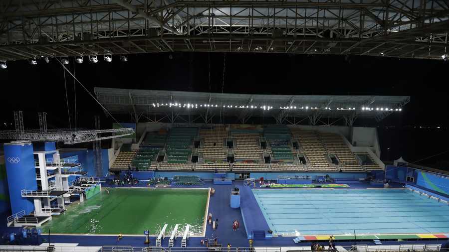 The water of the diving pool appears a murky green, in stark contrast to the pool's previous day's color and also that of the clear blue water in the second pool for water polo at the venue as divers train in the Maria Lenk Aquatic Center at the 2016 Summer Olympics in Rio de Janeiro, Brazil, Tuesday, Aug. 9, 2016. 