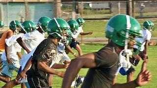 Students at Carver High School take the field for practice.