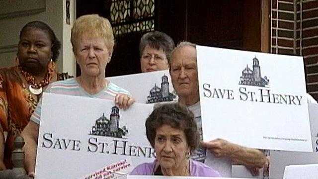 St. Henry Catholic Church parishioners protest the impending closure of their uptown church.