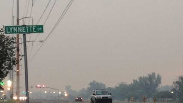 A gray cloud hovers above the roads of Jefferson Parish Wednesday night as a marsh fire burns nearby.