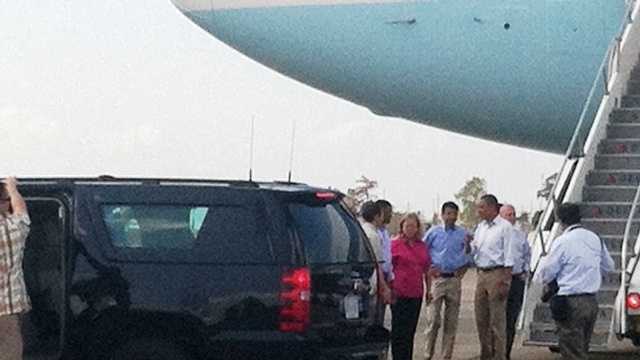 President Barack Obama is met by local and state leaders after arriving at Armstrong International Airport.