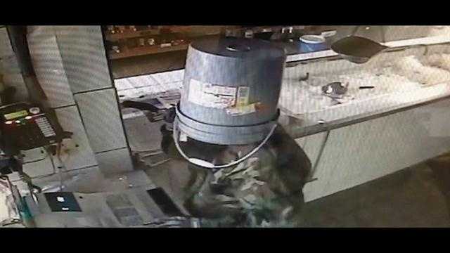 Raw Video: Burglar uses bucket to conceal identity