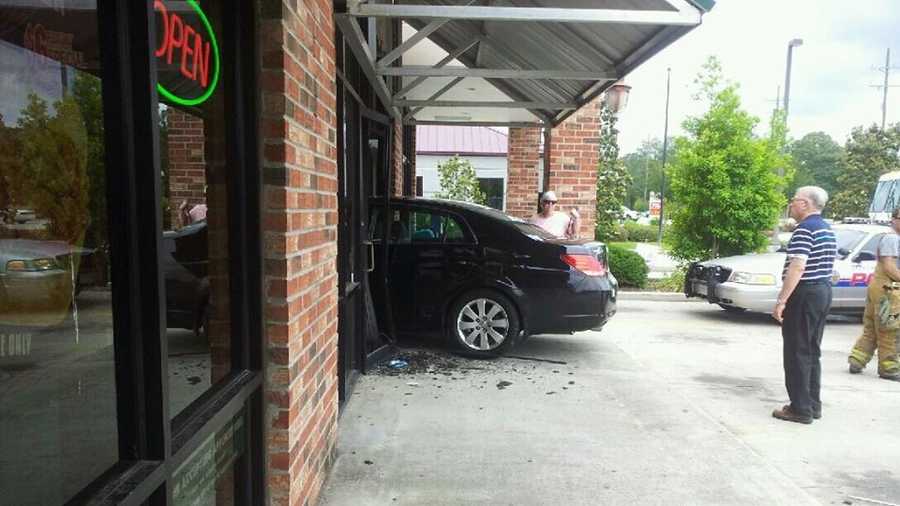 A vehicle protrudes from a strip mall in Covington after the driver apparently lost control.