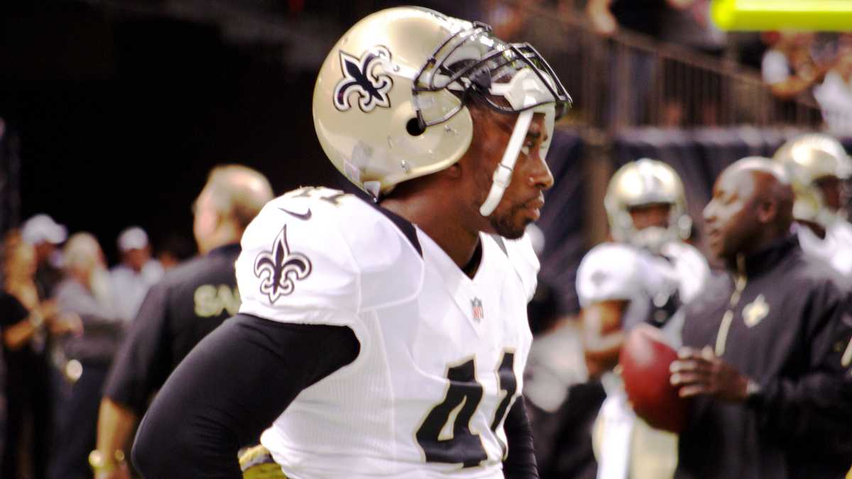 A stunned New Orleans Saints' Roman Harper walks off the field as