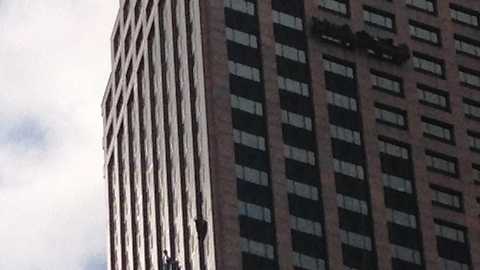 A worker awaits rescue from a failed window washing platform on a Central Business District high rise.