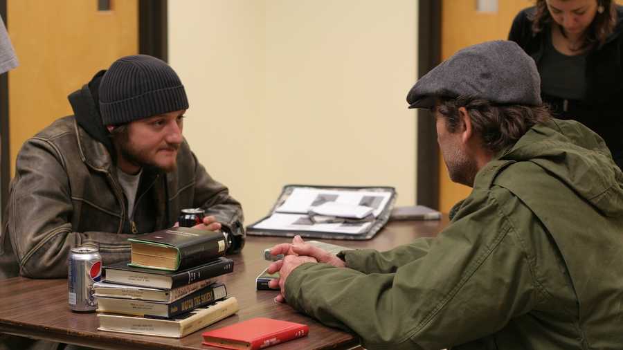 Director James Roe (left) talks to actor Tracy Miller on the set of the film “AM800.” This scene was shot in UNO’s Earl K. Long Library.