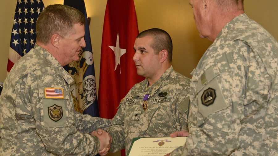Spc. Williams Hernandez of Kenner, La. receives Purple Heart combat decoration at an official ceremony at Camp Beauregard in Pineville, La., on Novemeber 13, 2013.