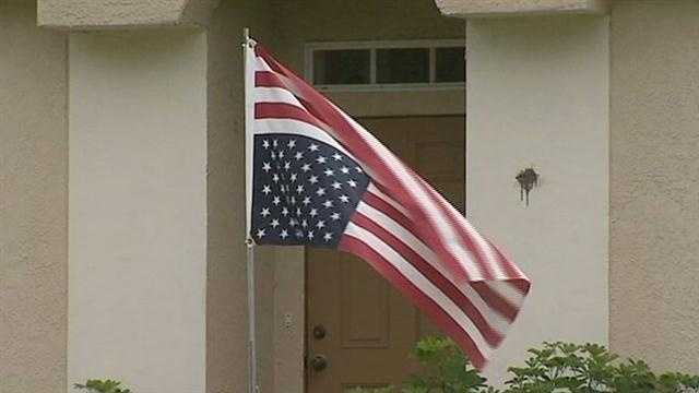A man flying an upside-down U.S. flag in Palm Bay is attracting a lot of attention and drawing the ire of some of his neighbors.