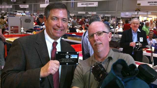 WESH 2's Greg Fox and Tim Brown pose with the coin.