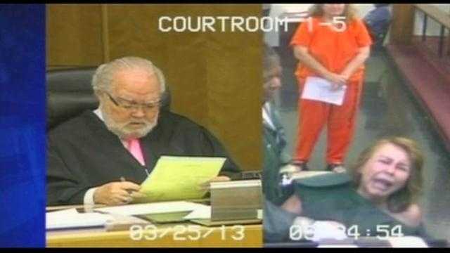 Woman accused of killing husband screams in court
