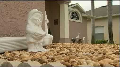 A Port Orange woman says it's a sin that her homeowner's association is ordering her to remove a statue of an angel from her front yard.