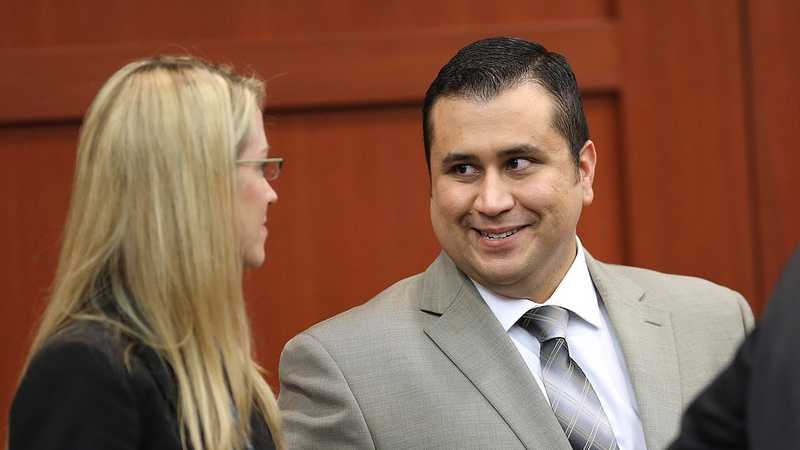 George Zimmerman chats with Brandy Dixon an assistant from his defense team, during his trial in Seminole circuit court, in Sanford, Fla., Tuesday, July 9, 2013. Zimmerman is charged with 2nd-degree murder in the fatal shooting of Trayvon Martin, an unarmed teen, in 2012. (Joe Burbank/Orlando Sentinel/POOL)